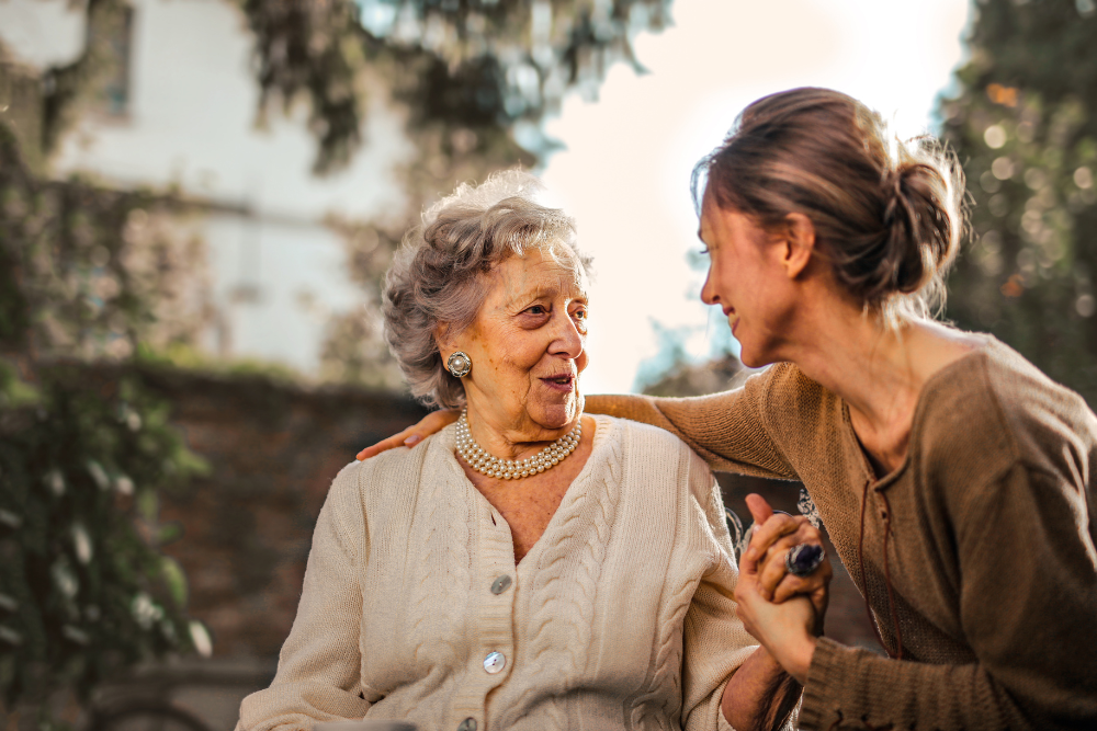 Image of family member taking care of an elderly parent.